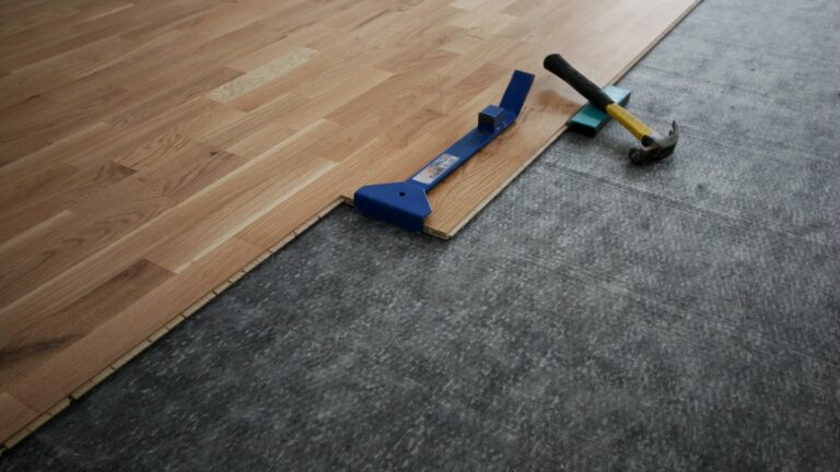 Installation of wooden flooring with tools on a concrete surface